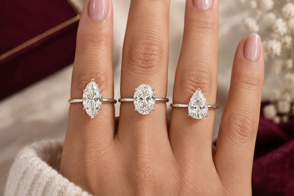 Marquise, oval, and pear diamonds on a hand