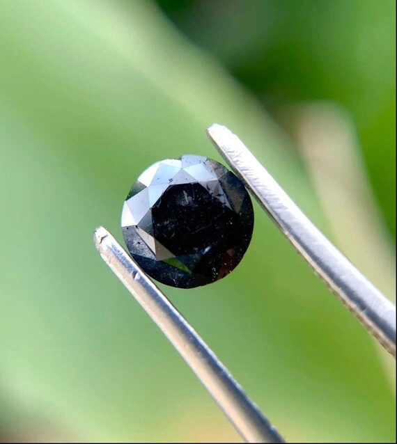 Close-up of a polished black diamond showing its dark appearance